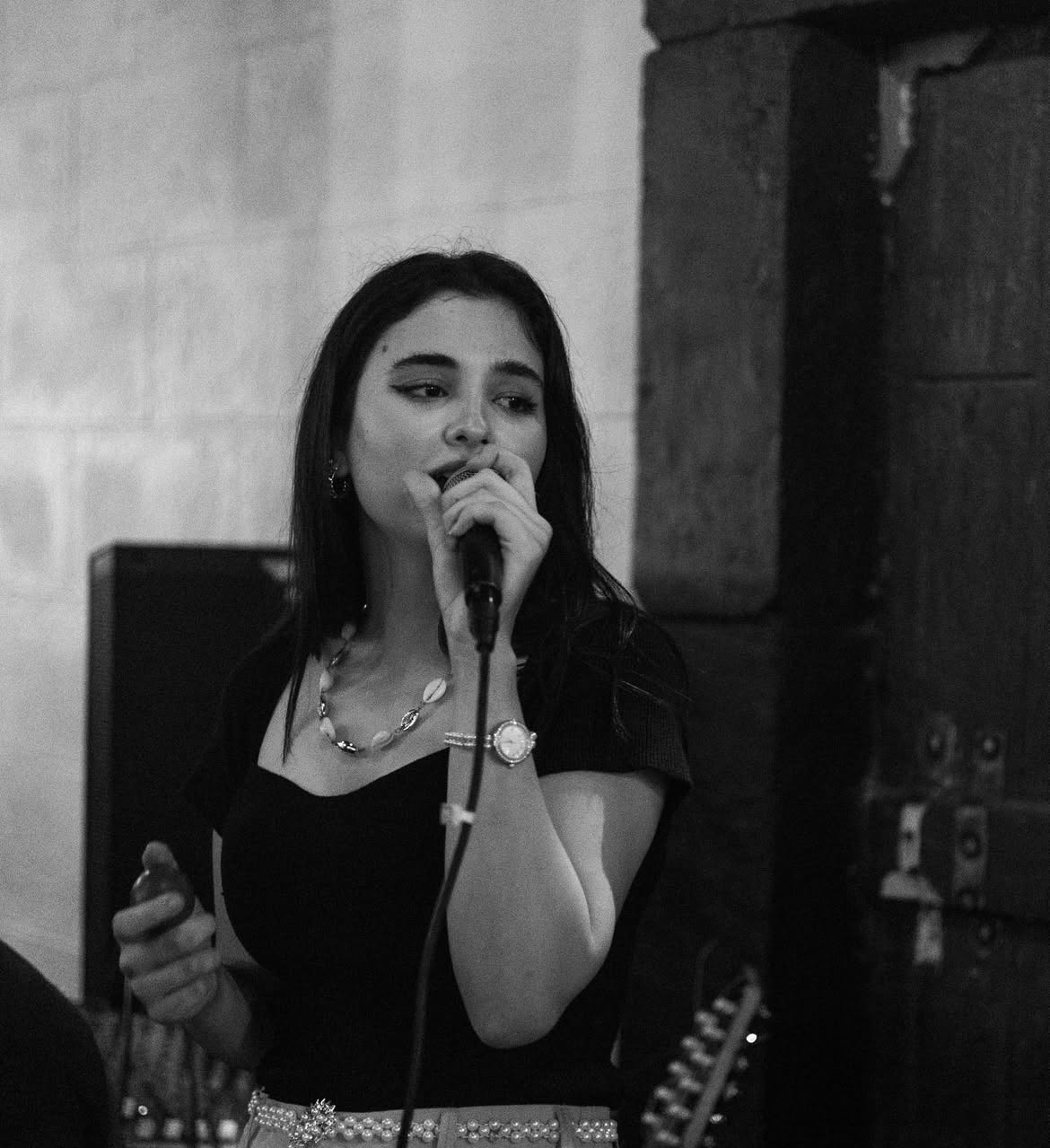 Black and white close portrait of Lana singing