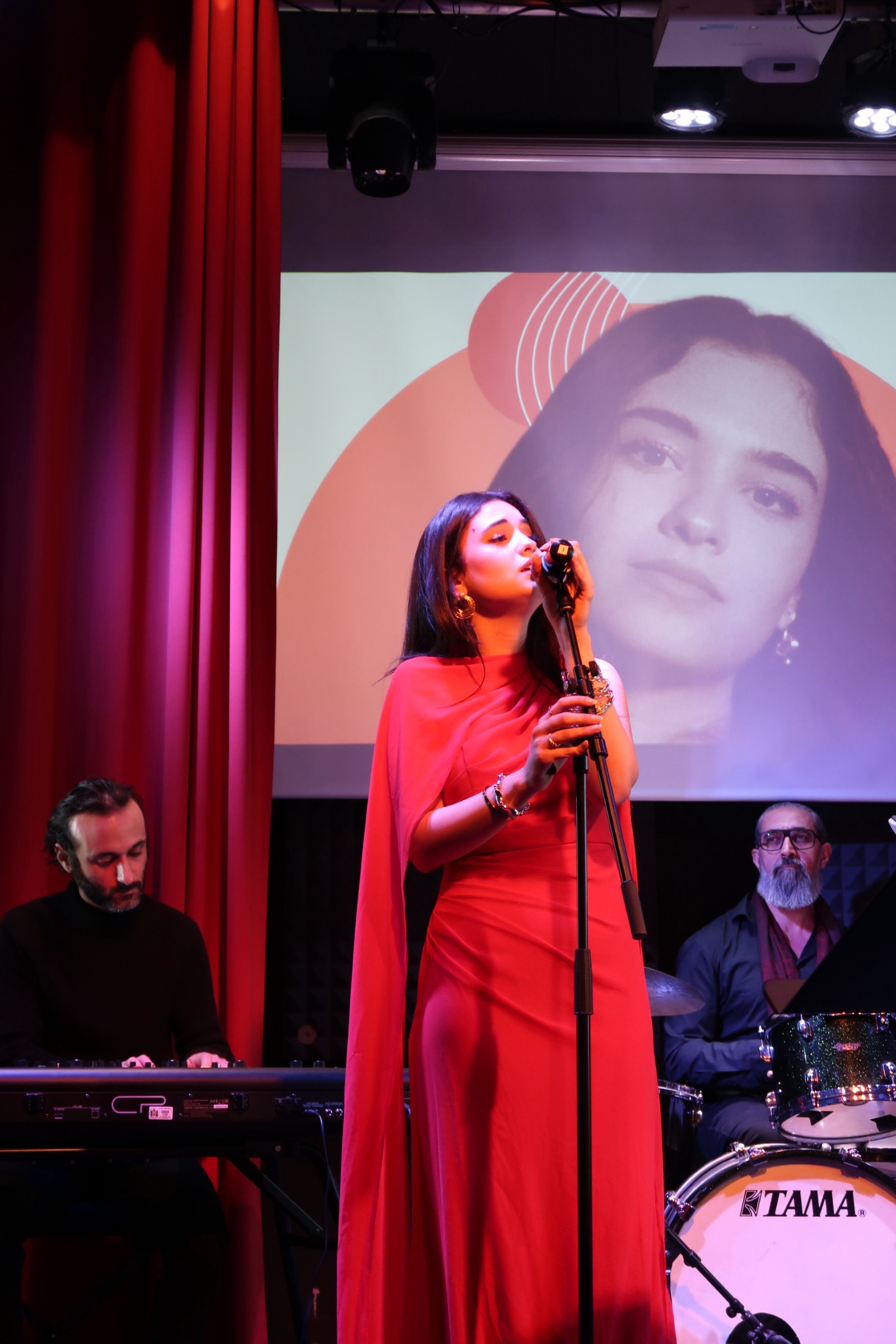 Lana Oudeh singing in a red dress